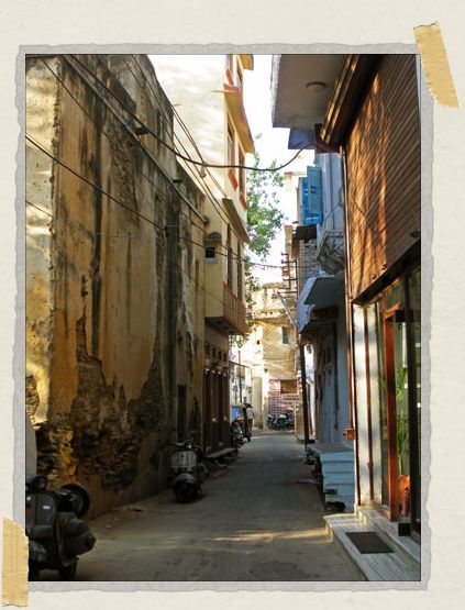 A rare quiet street with beautiful crumbling buildings on either side 'A rare quiet street with beautiful crumbling buildings on either side